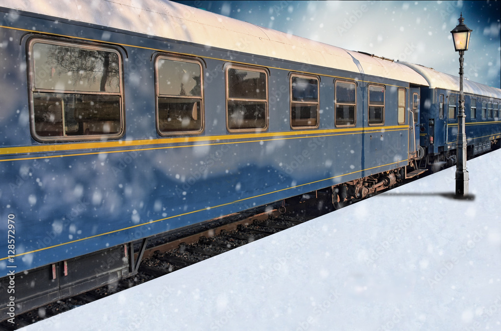 Classic train on snowy platform with lantern in winter