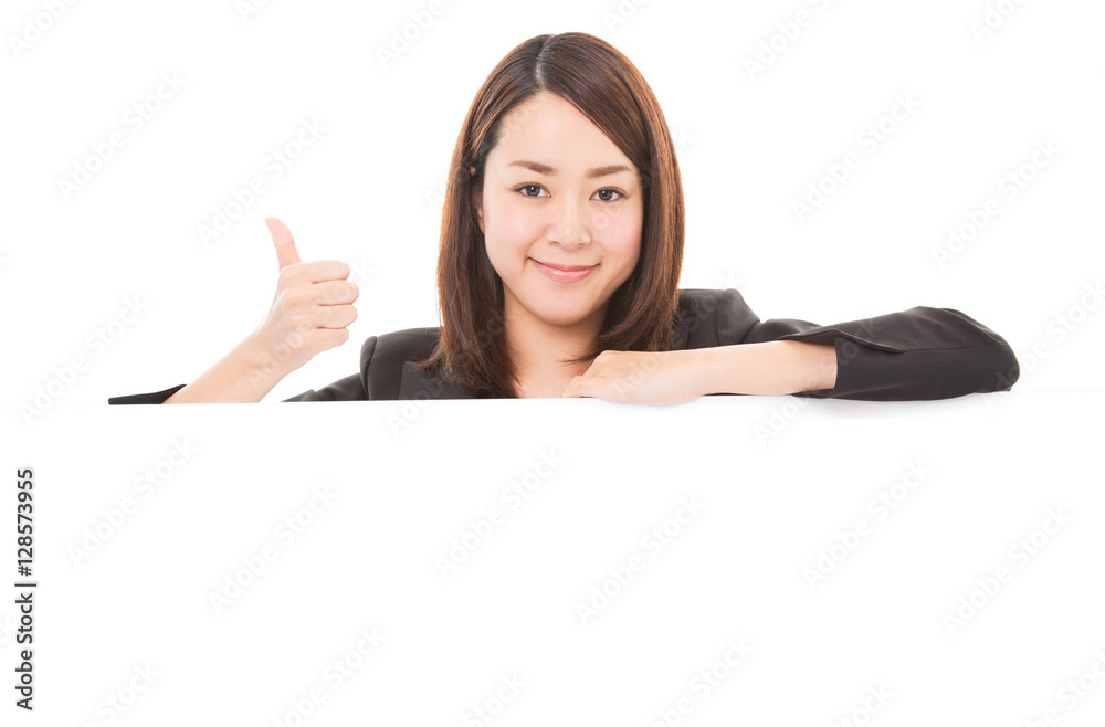 Business woman showing thumb up sign on white board Business woman showing thumb up sign on white board