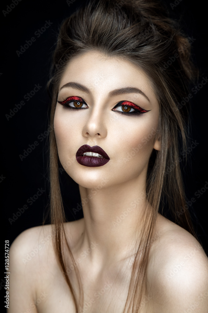 Beautiful woman portrait in asian style with red eyeshadows on black background. Beautiful woman portrait in asian style with red eyeshadows on black background.