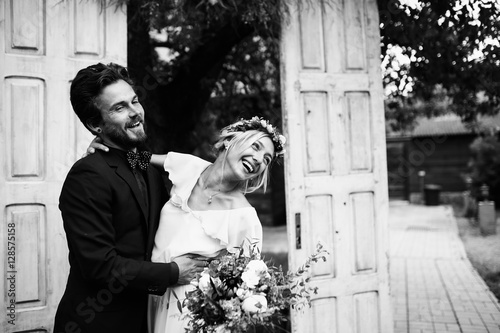 Funny bride and groom near the wedding arch