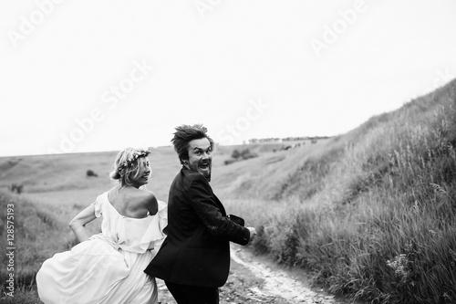 Funny running bride and groom