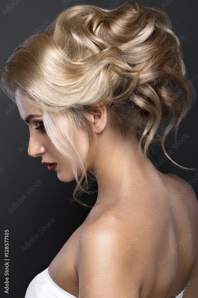 Beautiful blond girl with perfect skin, evening make-up, wedding hairstyle.Beauty face. Picture taken in the studio. Beautiful blond girl with perfect skin, evening make-up, wedding hairstyle.Beauty face. Picture taken in the studio.