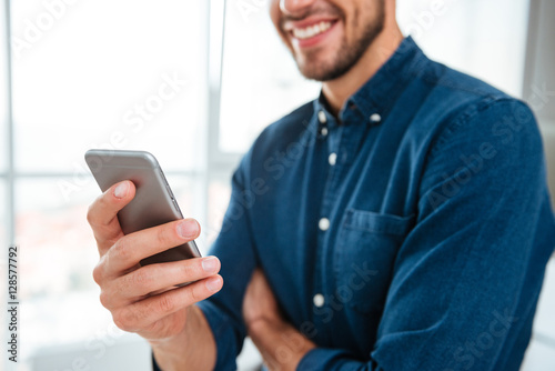 Cropped photo of young man using his smartphone