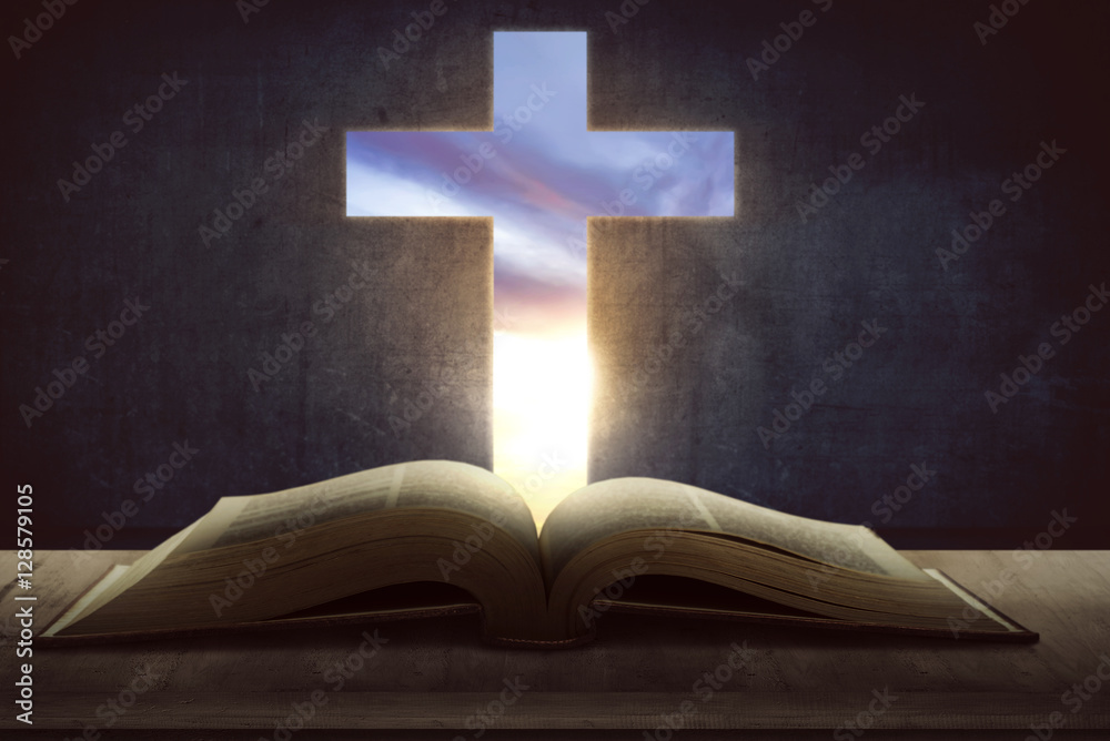 Open holy bible with wooden cross in the middle Open holy bible with wooden cross in the middle