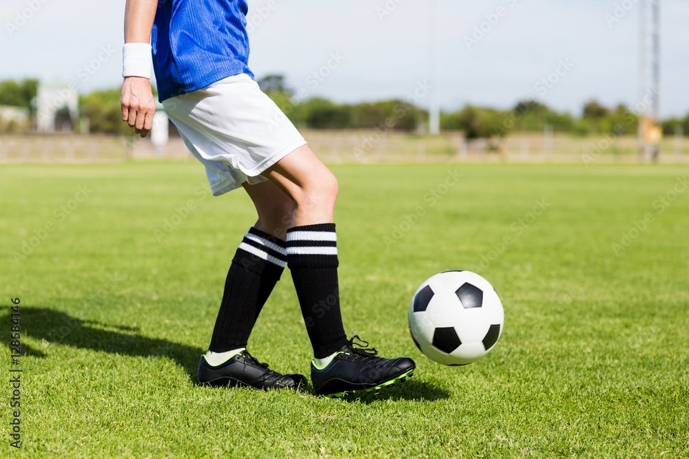 Female football player practicing soccer Female football player practicing soccer