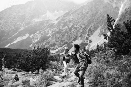 incredibly beautiful and young couple runing in the mountains