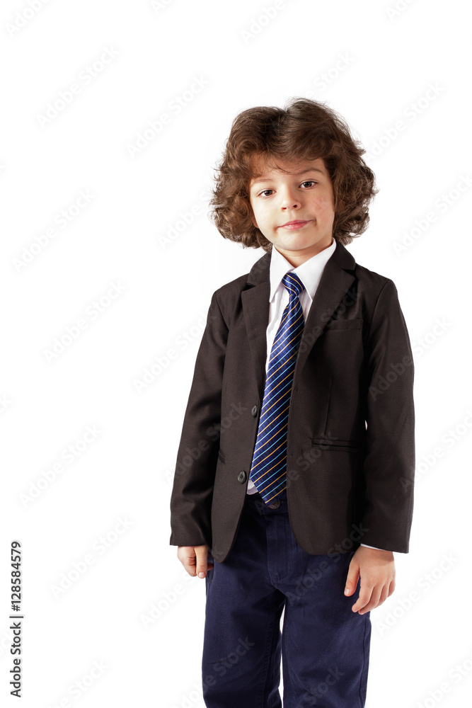 Cute curly boy stands and looking thoughtfully into the camera. White background. Cute curly boy stands and looking thoughtfully into the camera. White background.