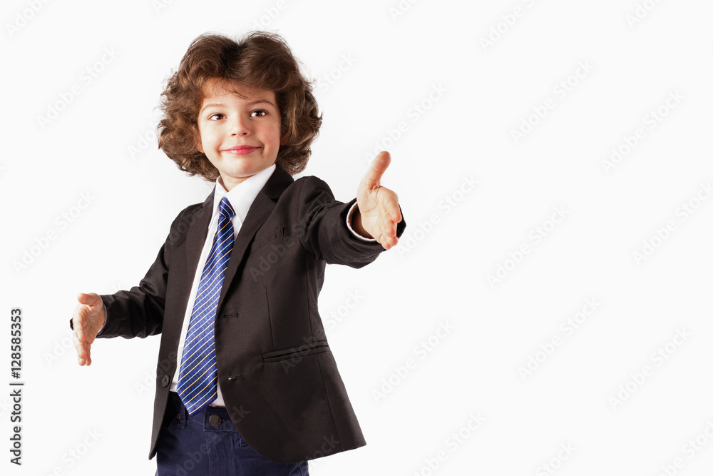 Curly happy boy stands, raised his hands. White background. Curly happy boy stands, raised his hands. White background.