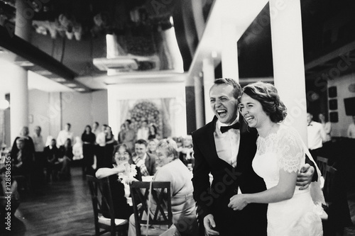 Cheerful smile of the newlyweds on the wedding party
