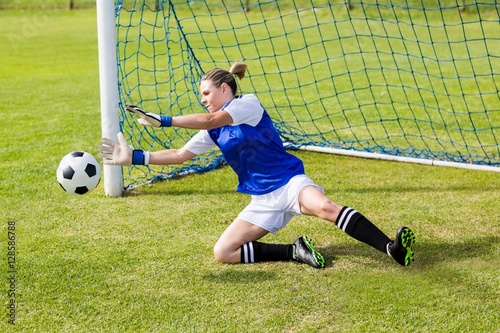 Bild auf Leinwand Female goalkeeper saving a goal