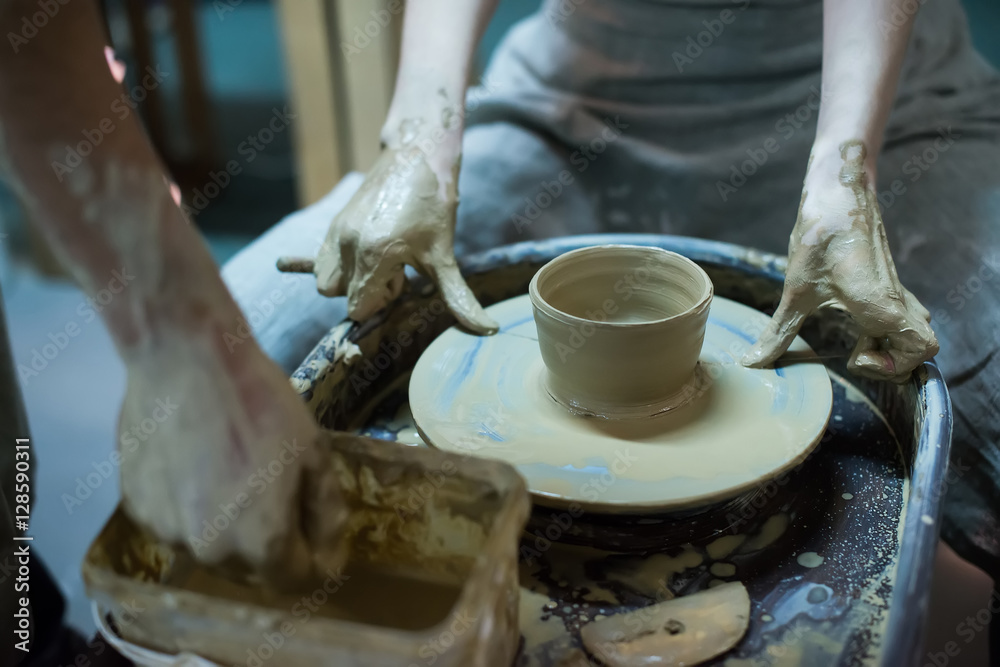 Hands working on pottery wheel Hands working on pottery wheel