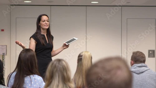 Female teacher addressing university students in class, shot on R3D photo
