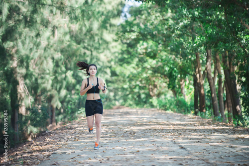 Young fitness woman jogging in park.