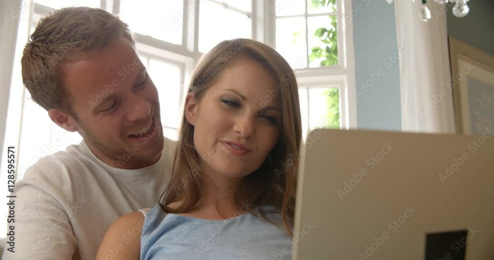 Couple Relaxing On Sofa Using Laptop Computer Shot On R3D Couple Relaxing On Sofa Using Laptop Computer Shot On R3D