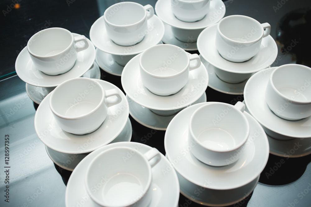 served with cups and saucers on the table served with cups and saucers on the table