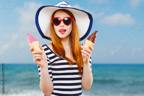 Girl with hat and sunglasses holding ice-creams