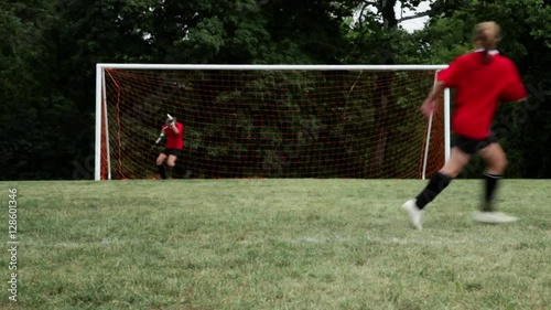 Soccer player hitting crossbar with ball