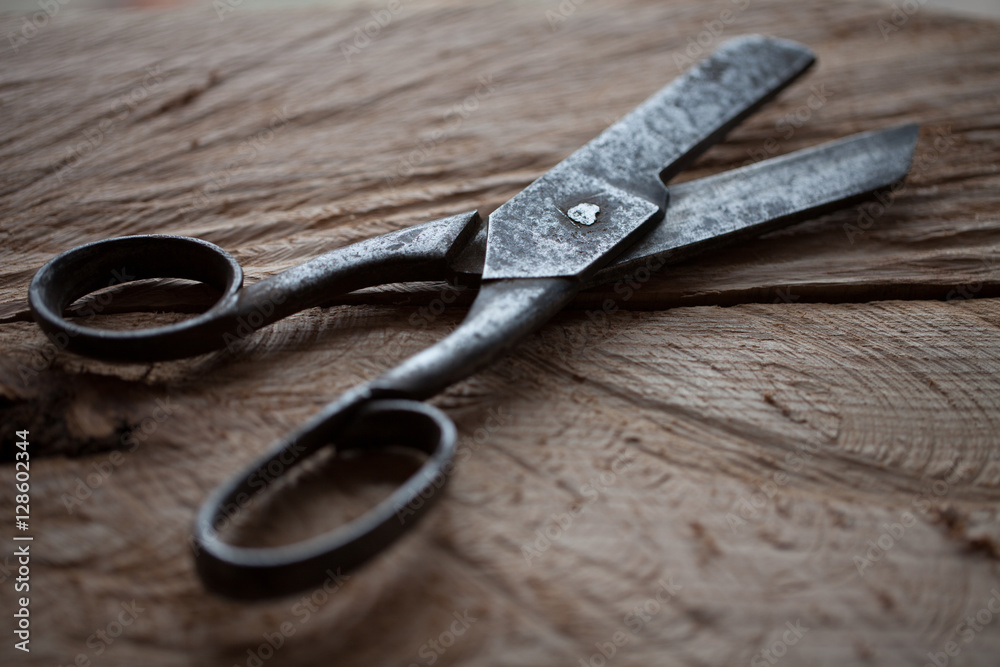 old scissors on a wooden rustic background old scissors on a wooden rustic background