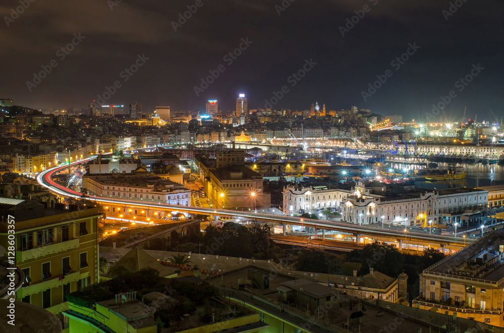 City of Genoa at night with beautifully lit harbor and busy streets full of traffic