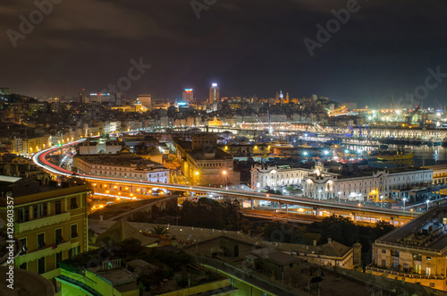 City of Genoa at night with beautifully lit harbor and busy streets full of traffic