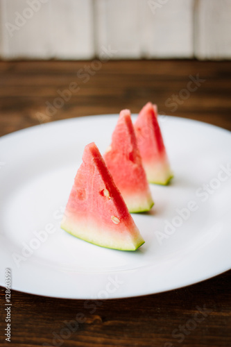 Small pieces of watermelon on white plate.