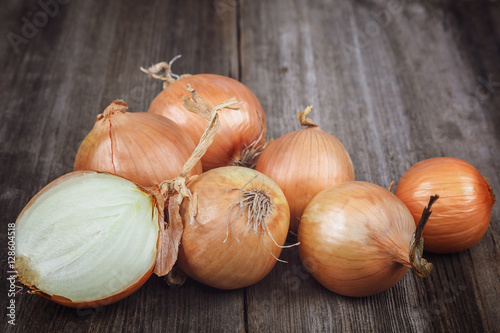 Fresh onions on a wooden background