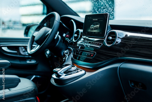 Luxury car interior details. Dashboard, steering wheel