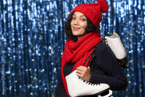 Woman carrying a pair of ice skates