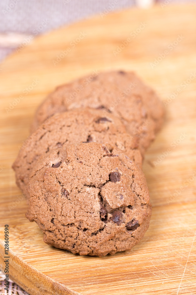 Fototapeta premium Brown chocolate biscuits on the wooden board