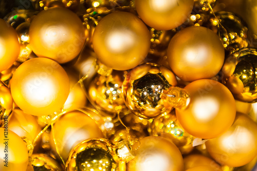 Many Christmas golden balls in basket and star in colorful xmas Background