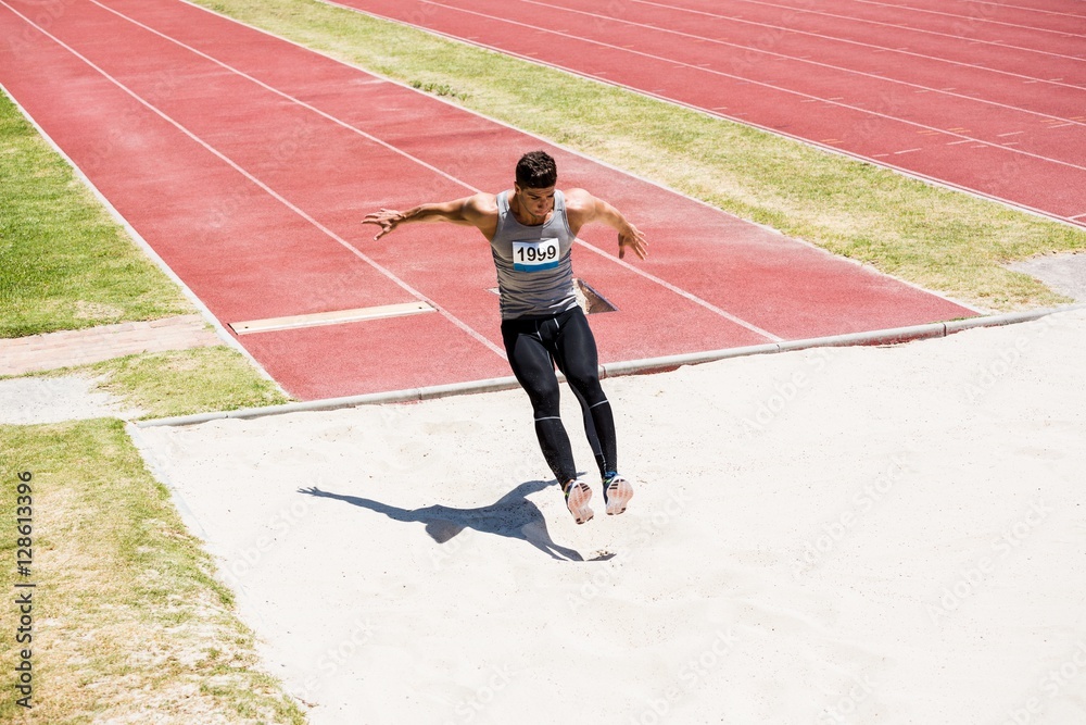 Fototapeta premium Athlete performing a long jump