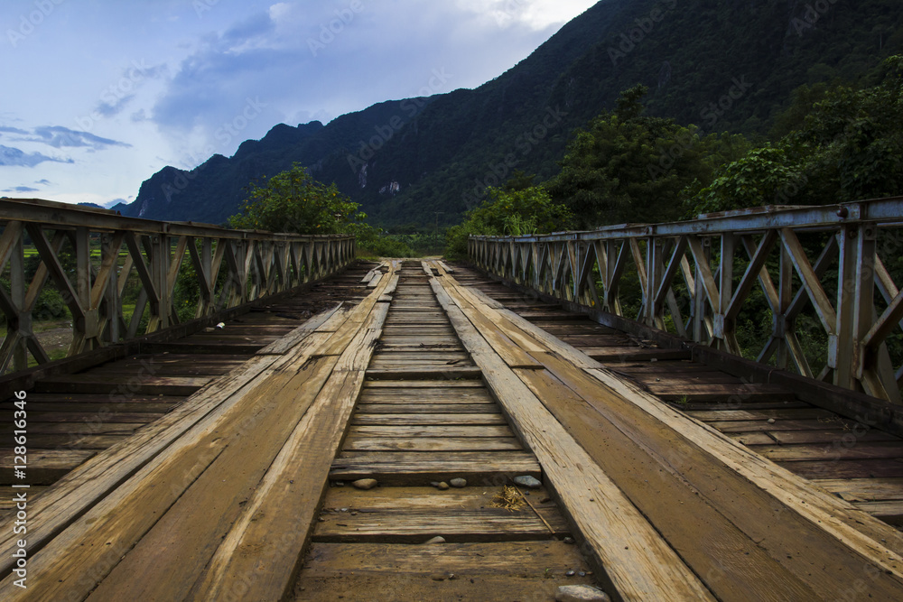 worn out wooden bridge in laos countryside