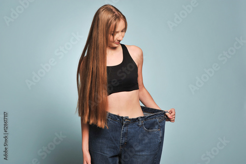 Women shows her weight loss.
