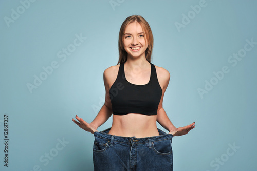 Fit young woman in loose jeans