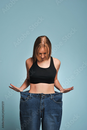 Fit young woman in loose jeans