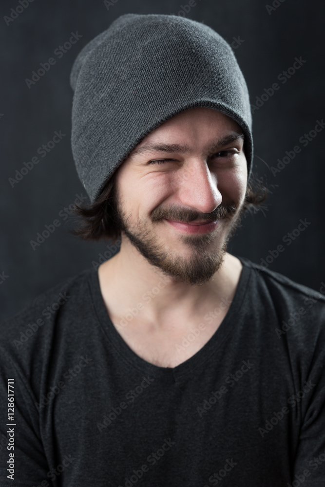 Portrait of a fashionable young man on dark background, chalkboa