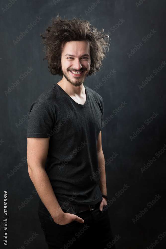 Portrait of a fashionable young man on dark background, chalkboa