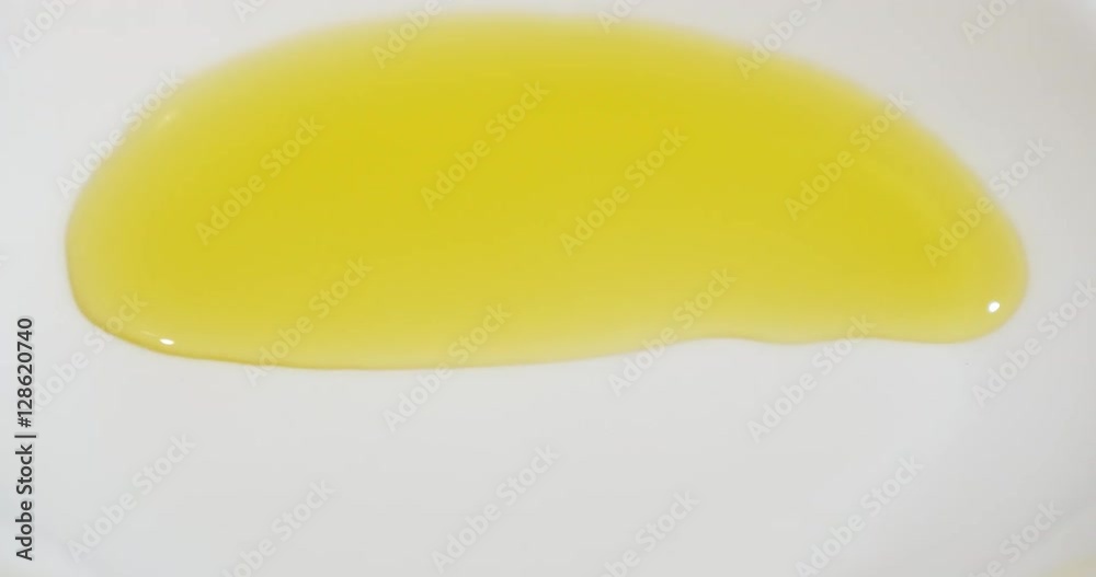 Spreading olive oil on plate Spreading olive oil on plate
