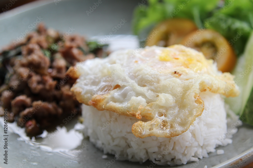Stir-fried pork with basil leaves and fried egg on rice. Stir-fried pork with basil leaves and fried egg on rice.