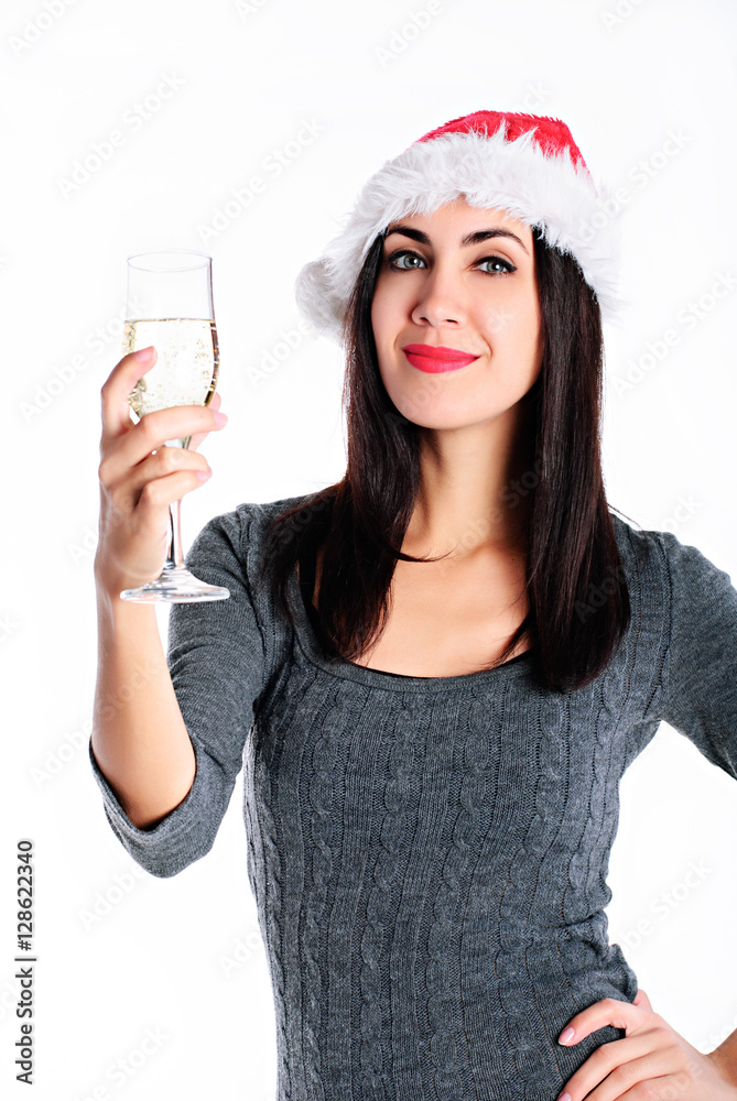 Young lovely woman in santa hat with glass of champagne on white background Young lovely woman in santa hat with glass of champagne on white background