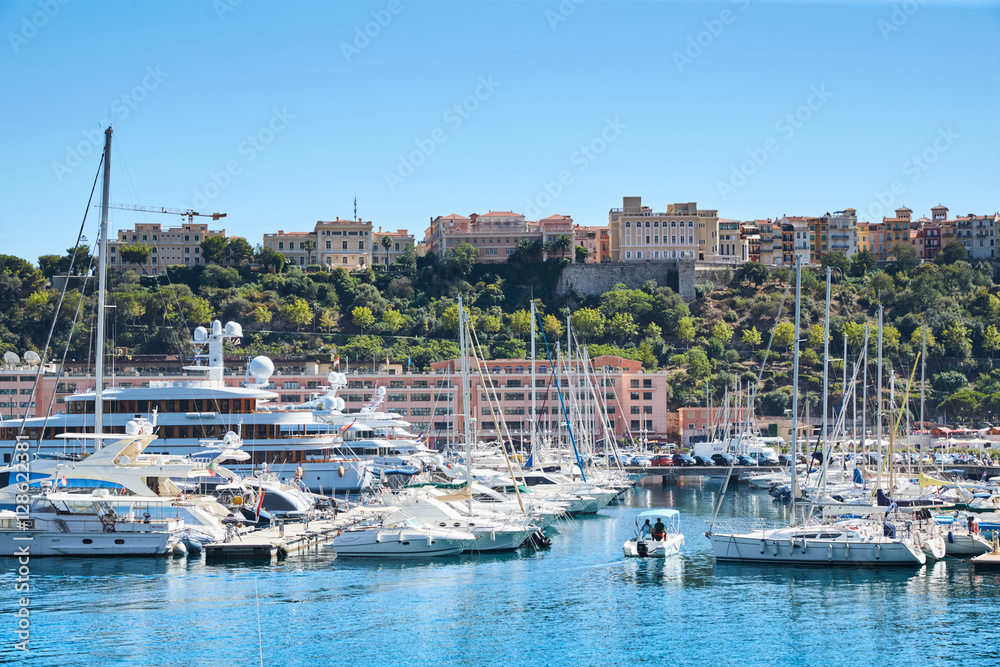 Monaco, Monte-Carlo, Monaco Ville, 8 August 2016: Port Hercules, the preparation of the yacht show MYS, sunny day, many yachts and boats, RIVA, Prince's Palace of Monaco, megayachts, Massif of houses