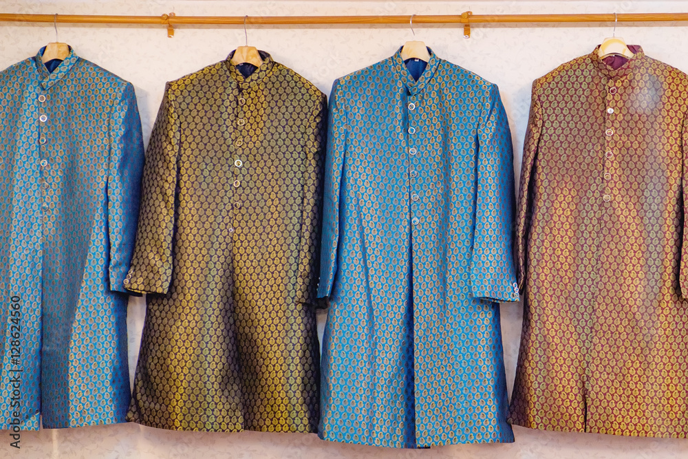 Traditional Indian men's clothing for sale at the street market in  Chinatown district, Bangkok, Thailand. Achkan or Sherwani is a long jacket  made of silk with buttons foto de Stock | Adobe
