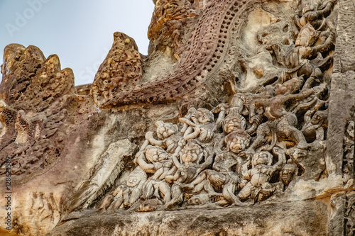 Mythological battle scenes of the ancient Khmer on the wall of ancient temple complex Angkor Wat in Siem Reap, Cambodia. Selective focus