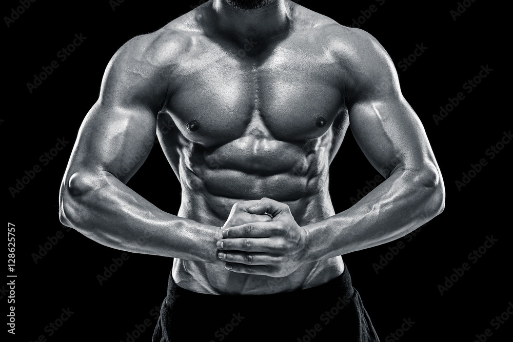 very muscular man posing with naked torso in studio very muscular man posing with naked torso in studio