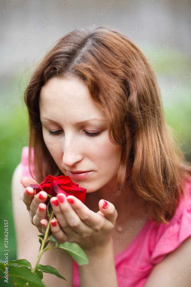 Portrait of young woman smelling rose in garden Portrait of young woman smelling rose in garden