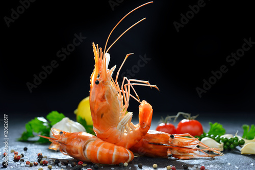 Cooked shrimps,prawns with seasonings on stone background photo