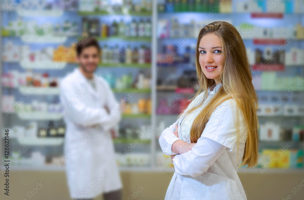 Happy young woman pharmacist over drugstore background