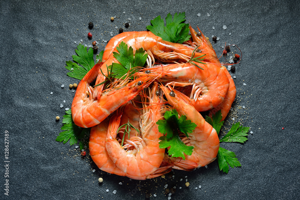 Cooked shrimps,prawns with seasonings on black stone background
Cooked shrimps,prawns with seasonings on black stone background