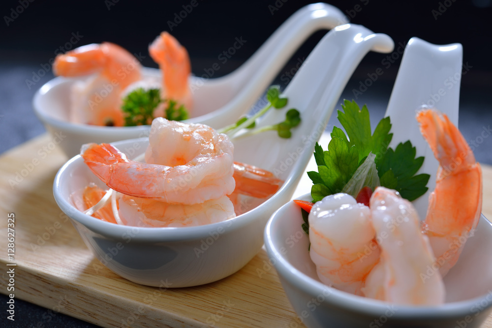 Cooked shrimps,prawns with seasonings on chopping board Cooked shrimps,prawns with seasonings on chopping board