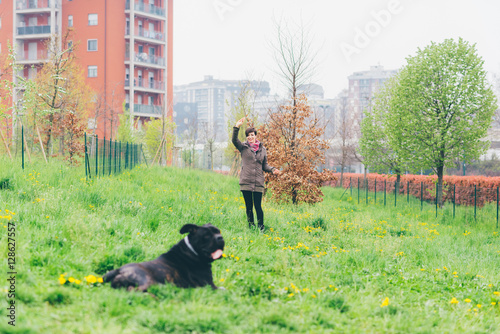 Young beautiful caucasian woman playing outdoor in a park with her dog - happiness, friendship concept © Eugenio Marongiu